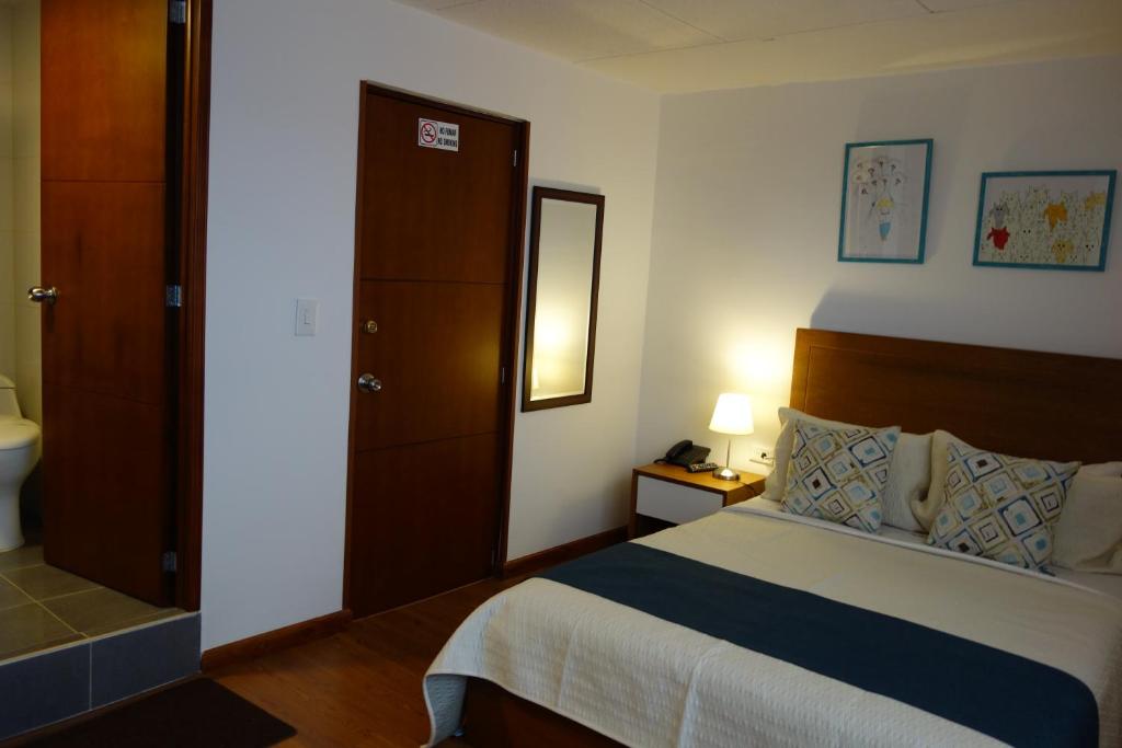 Postel nebo postele na pokoji v ubytování Hotel Maceo Chico