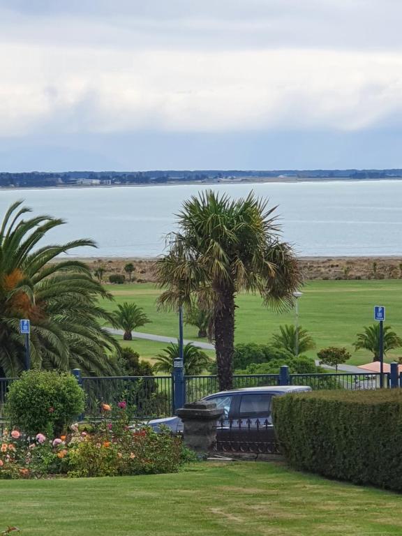 a view of the ocean from a park at Bayview Apartment in Timaru