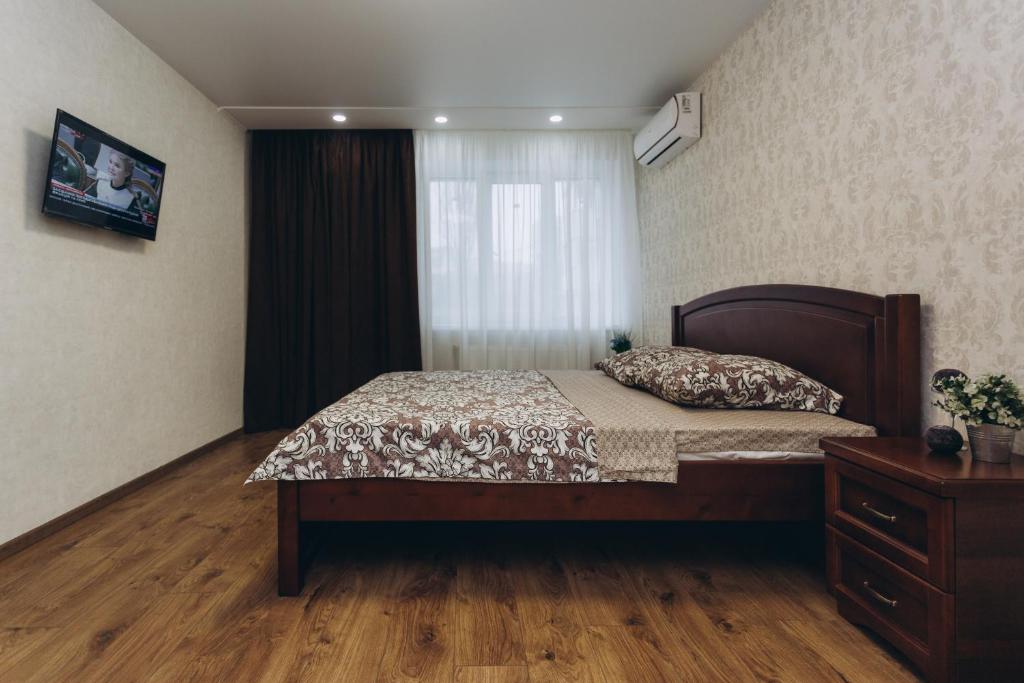 a bedroom with a bed and a window at Apart-smart on Kharkovskaya near Lavina 1 floor in Sumy