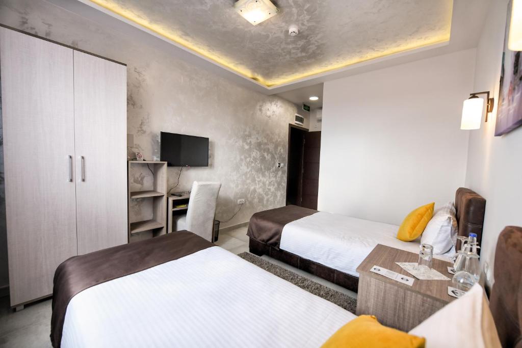 Postel nebo postele na pokoji v ubytování Garnet Hotel & Event Centar