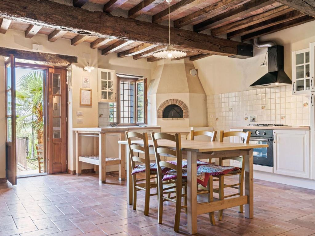 a kitchen with a table and chairs in a room at Belvilla by OYO Nord in Castellarano