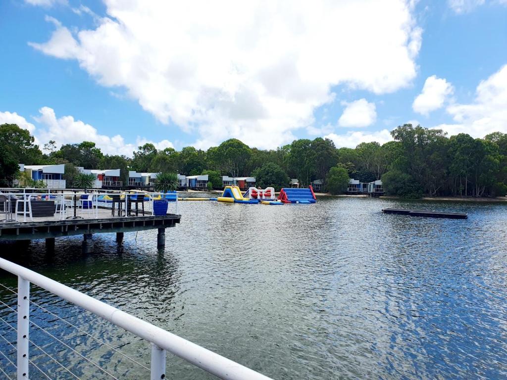 a view of a river with a dock and playground at Couran Cove Resort in Gold Coast