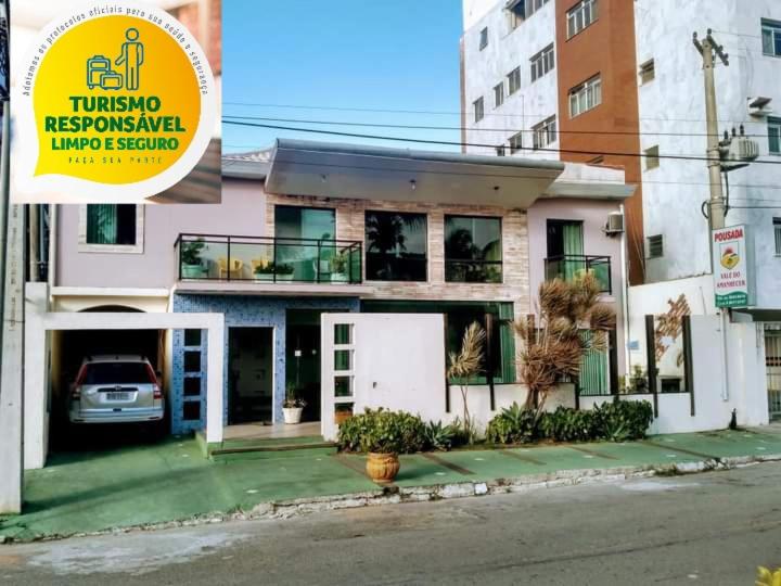 a house with a car parked in front of it at Pousada Vale do Amanhecer in Cabo Frio