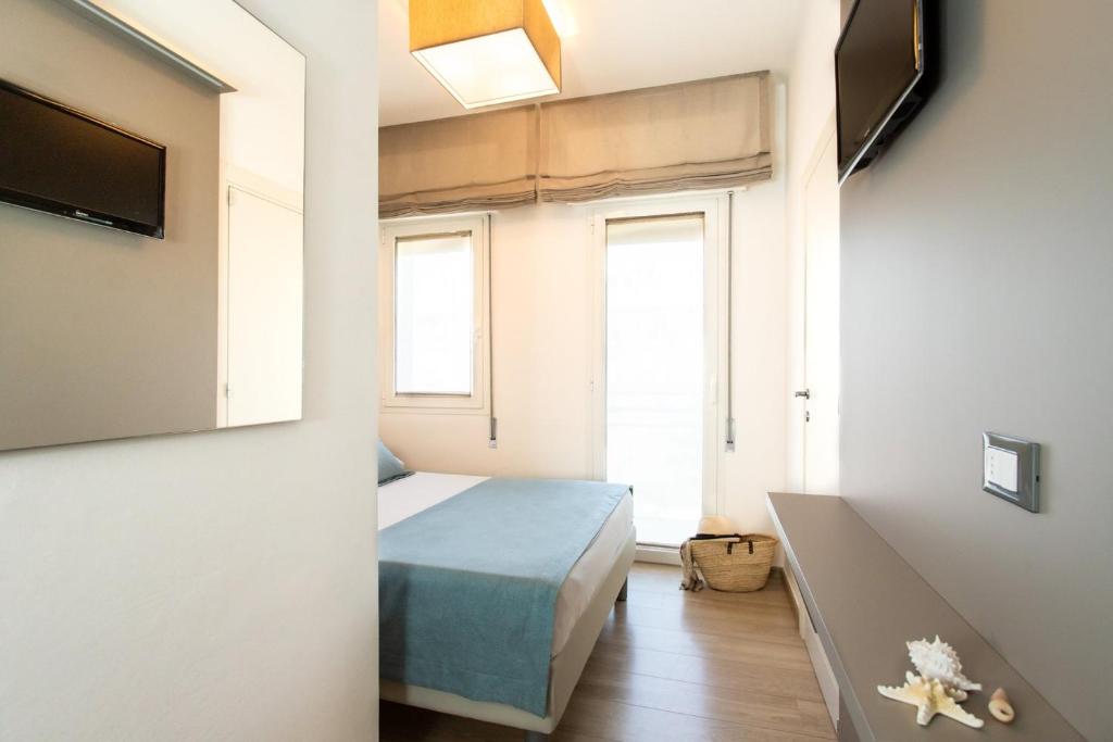 Postel nebo postele na pokoji v ubytování Hotel Delle Mimose