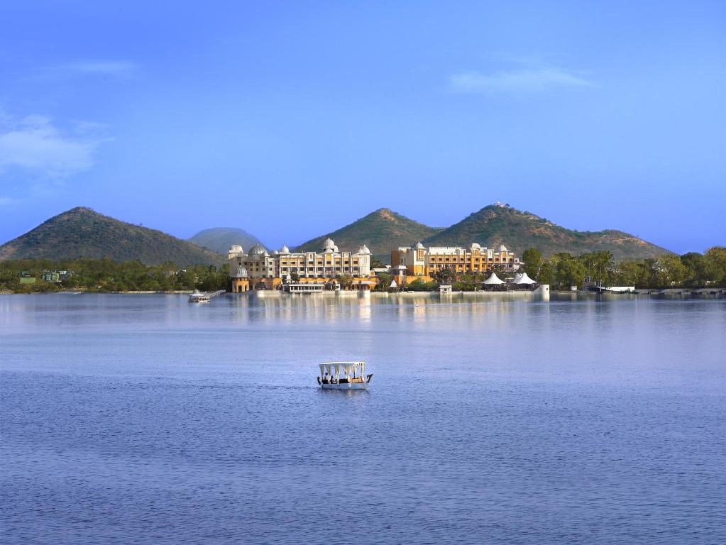 a small boat on a large body of water at The Leela Palace Udaipur in Udaipur