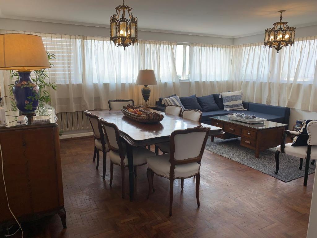 a living room with a table and a blue couch at Mirador de Plaza España in Cordoba