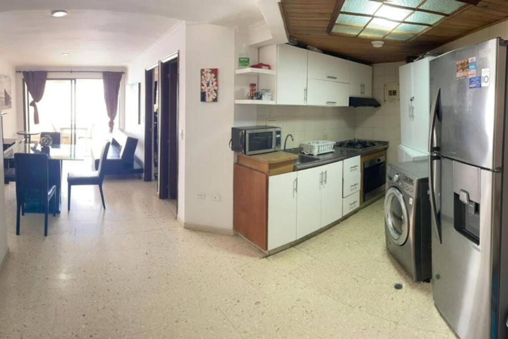 a kitchen with a refrigerator and a washing machine at Oferta frente a la playa Cartagena . En, Sp, It. in Cartagena de Indias