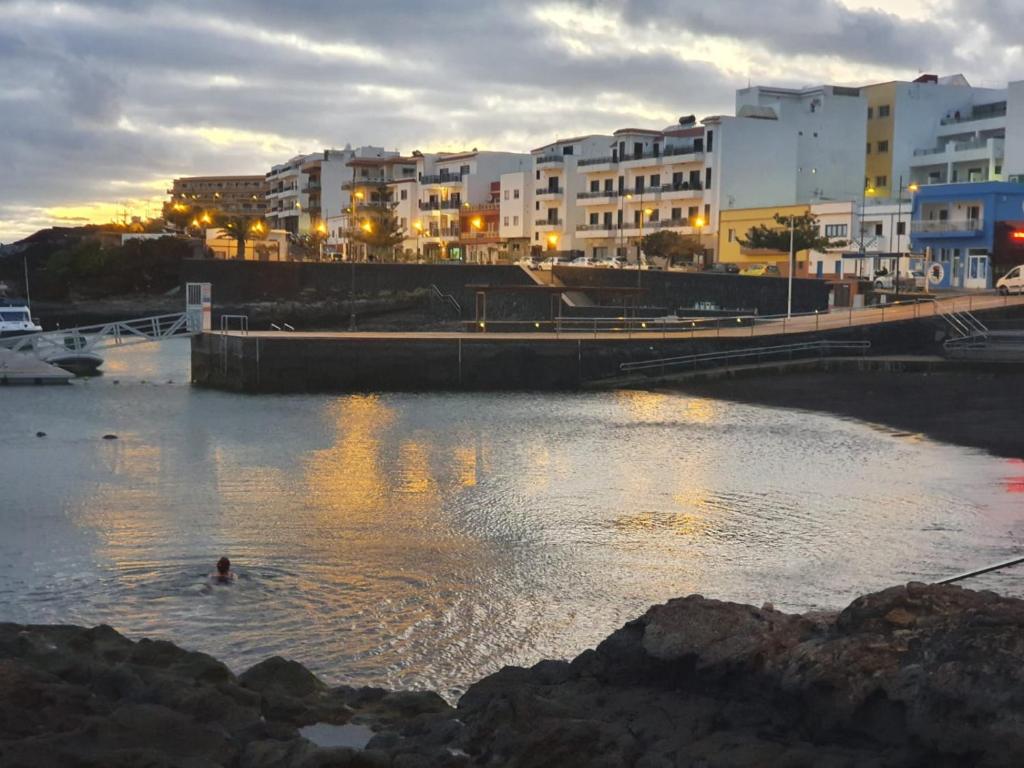 a person swimming in a river in a city at Arista Sur in La Restinga