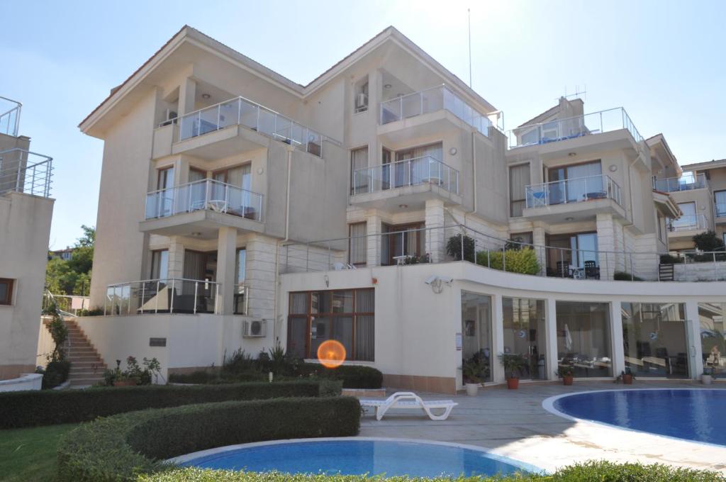 a large building with a swimming pool in front of it at Beautiful family villa with sea view in Byala