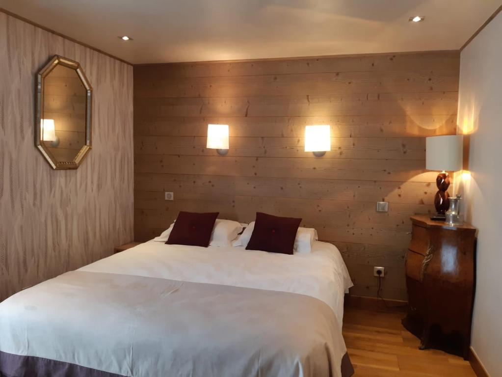 a hotel room with two beds and a mirror at Chalet Emilie in Courchevel