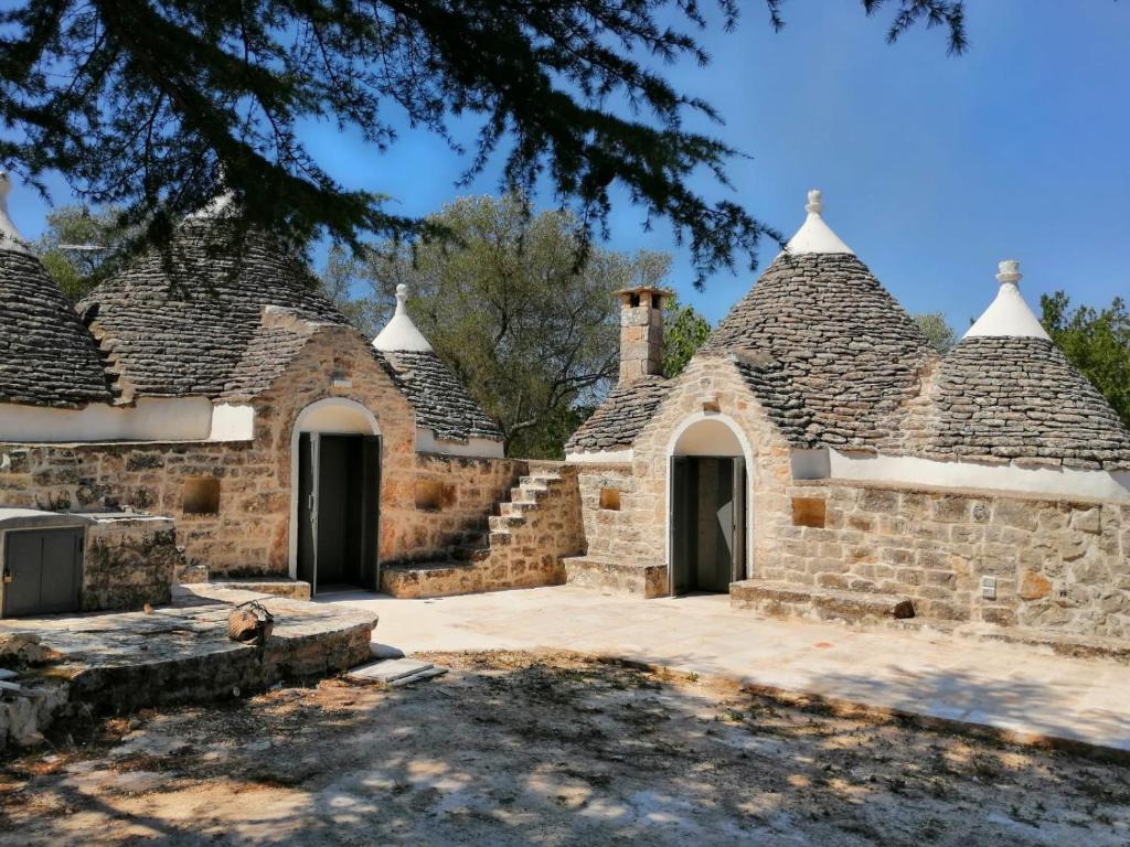 a group of stone buildings with turrets at Trullo Scrascia. in Ceglie Messapica