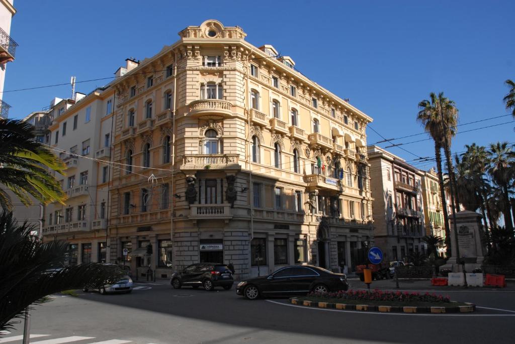 a large building with cars parked in front of it at Locanda Beatrice in Sanremo