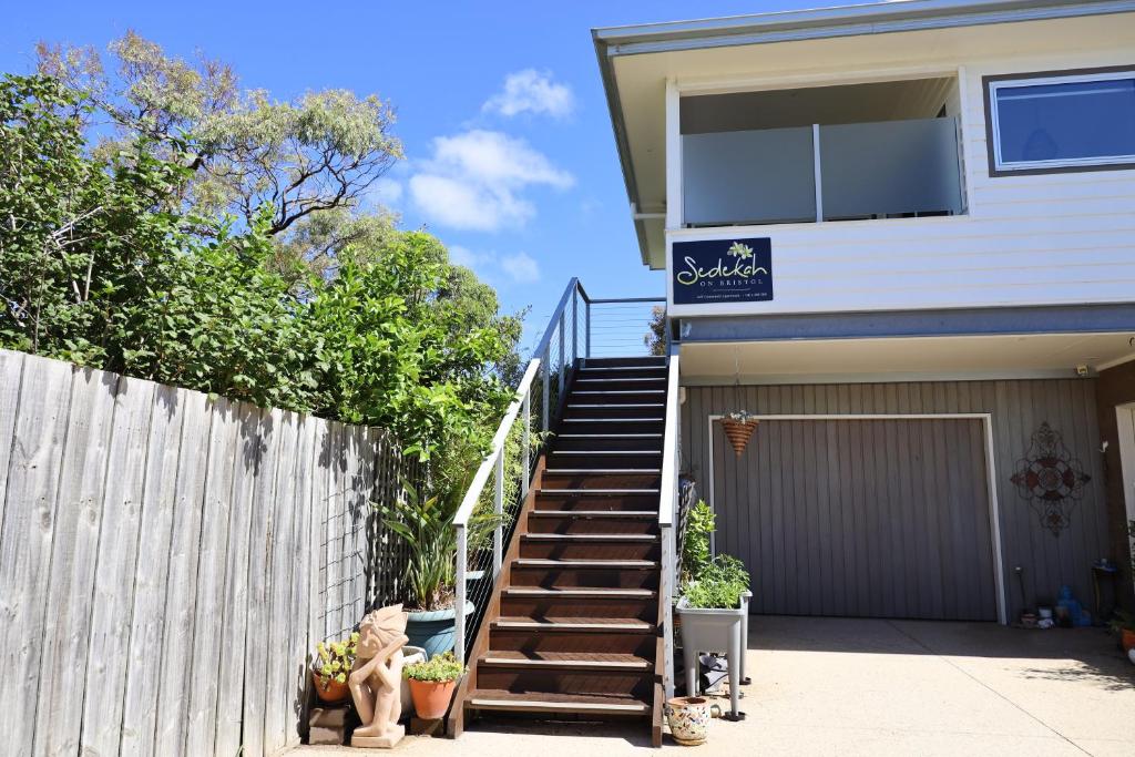 a house with stairs leading up to a garage at Sedekah on Bristol in Torquay