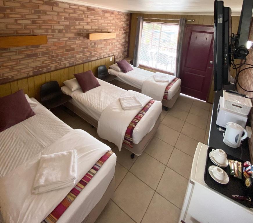 Postel nebo postele na pokoji v ubytování PROSERPINE MOTOR LODGE