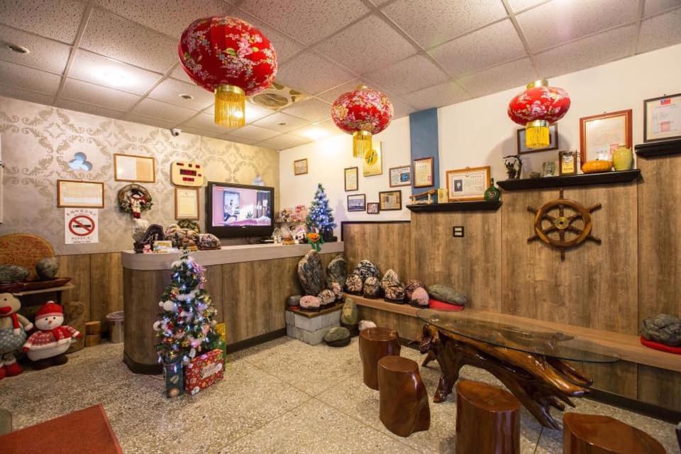una habitación con adornos de Navidad y un árbol de Navidad en ella en Gui Ren Sha Cheng Guest House, en Chenggong