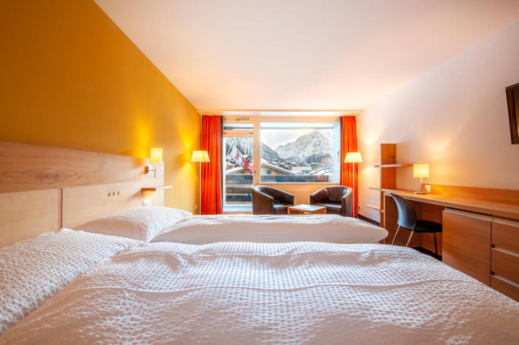 Postel nebo postele na pokoji v ubytování Hotel Gädi