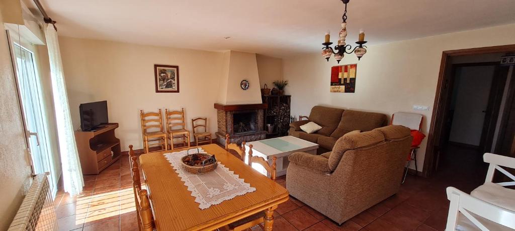 a living room with a couch and a table at Apartamento Rural Coll d'Ares in Ares del Maestre