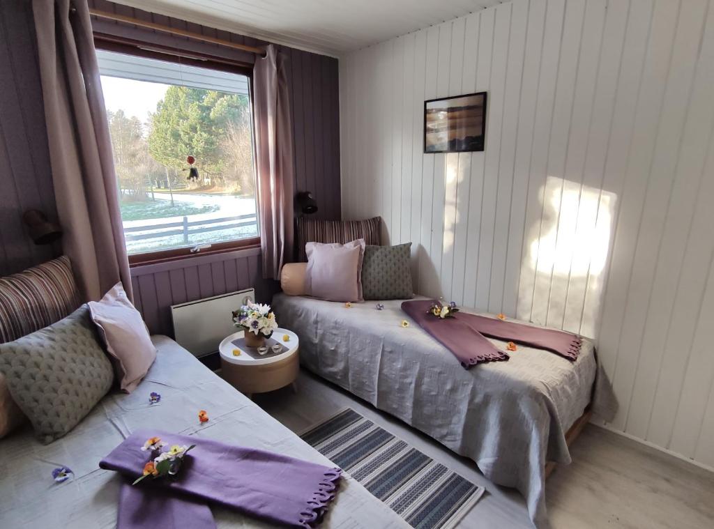 a bedroom with two beds and a window at Urhanen in Gedser