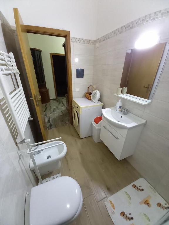 biała łazienka z toaletą i umywalką w obiekcie Bella Reggio w mieście Reggio di Calabria