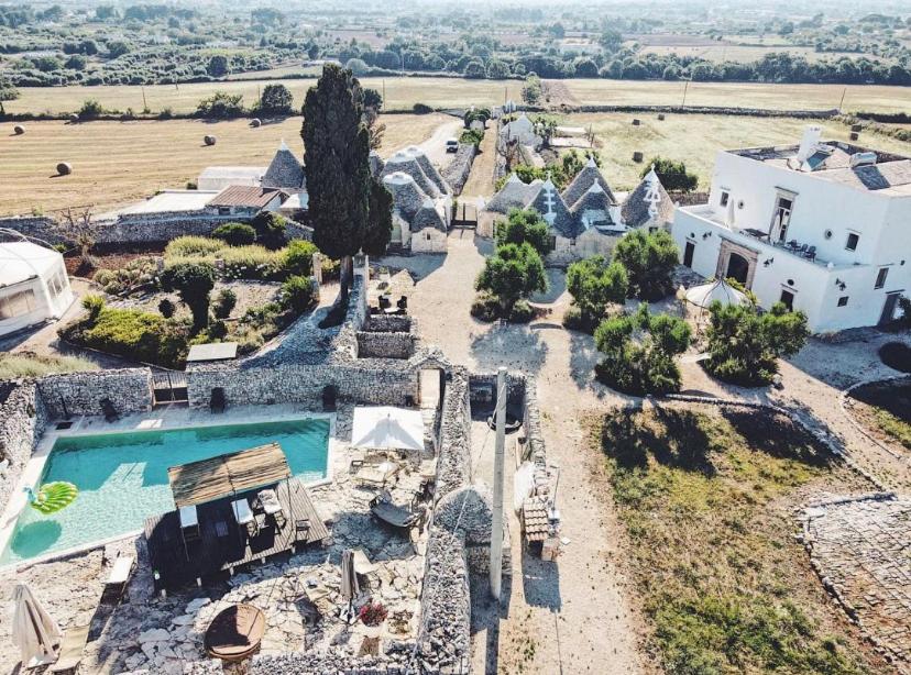 an aerial view of a villa with a swimming pool at Masseria Pavone in Martina Franca