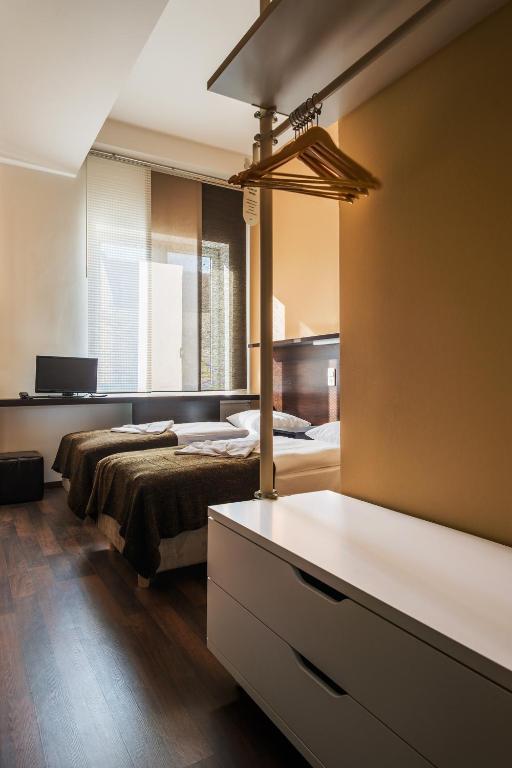 Postel nebo postele na pokoji v ubytování Apple City Hotel