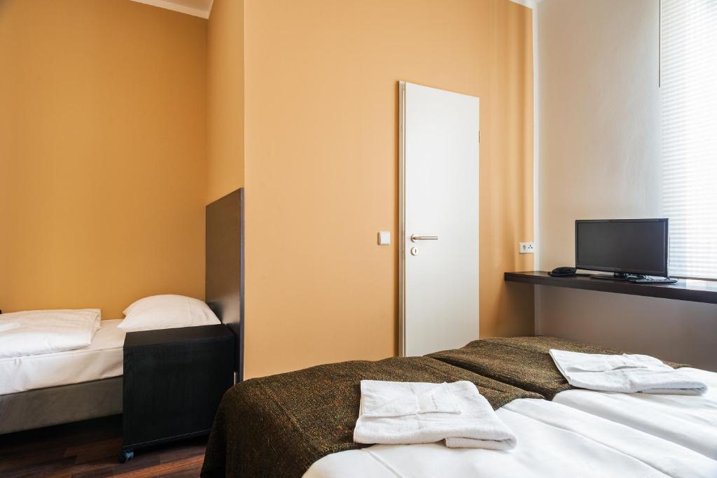 Postel nebo postele na pokoji v ubytování Apple City Hotel