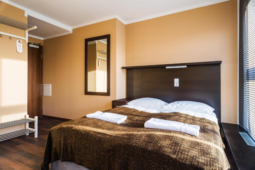 Postel nebo postele na pokoji v ubytování Apple City Hotel