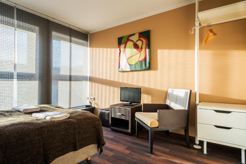 Postel nebo postele na pokoji v ubytování Apple City Hotel