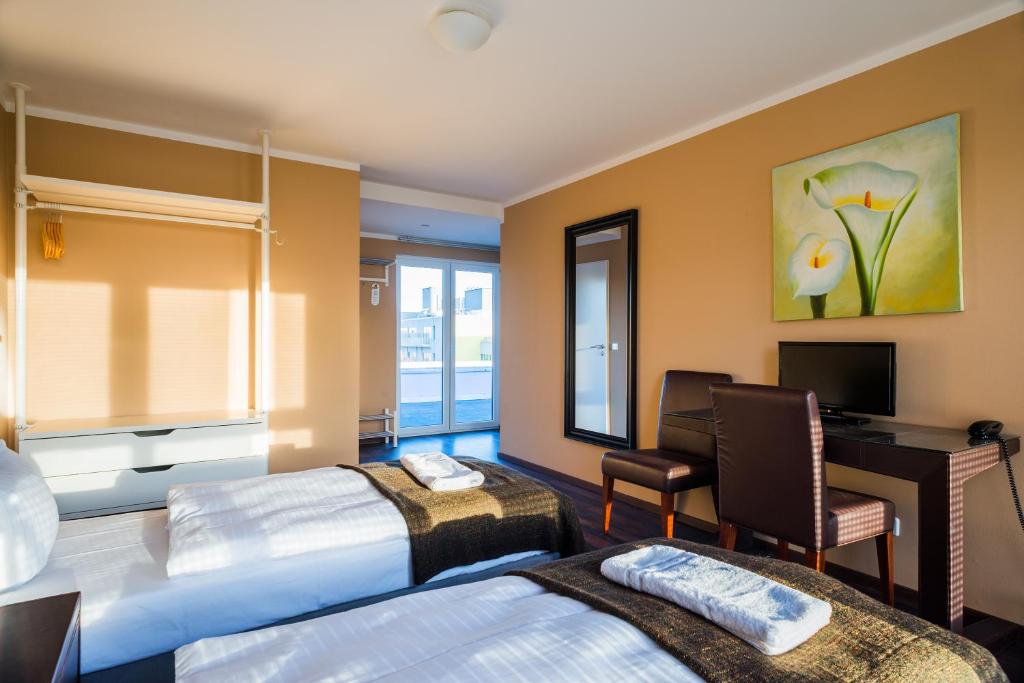 Postel nebo postele na pokoji v ubytování Apple City Hotel