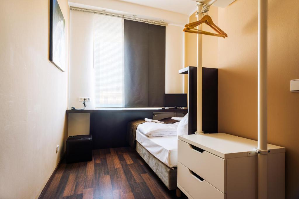 Postel nebo postele na pokoji v ubytování Apple City Hotel