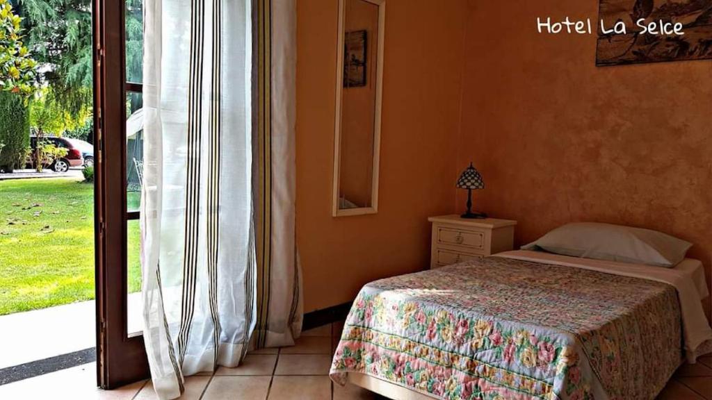 Postel nebo postele na pokoji v ubytování Hotel La Selce