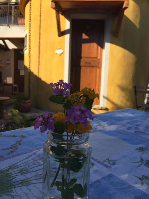 a glass jar with flowers in it on a table at C'era una volta Podere San Giovanni in Fossacesia