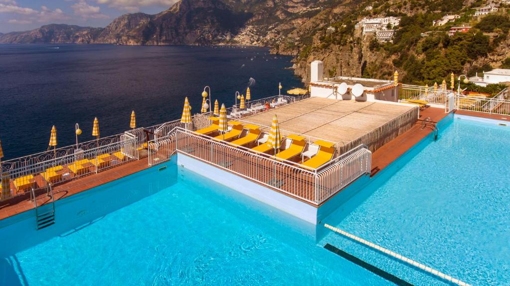 a swimming pool with a view of the water at Tramonto d'Oro in Praiano