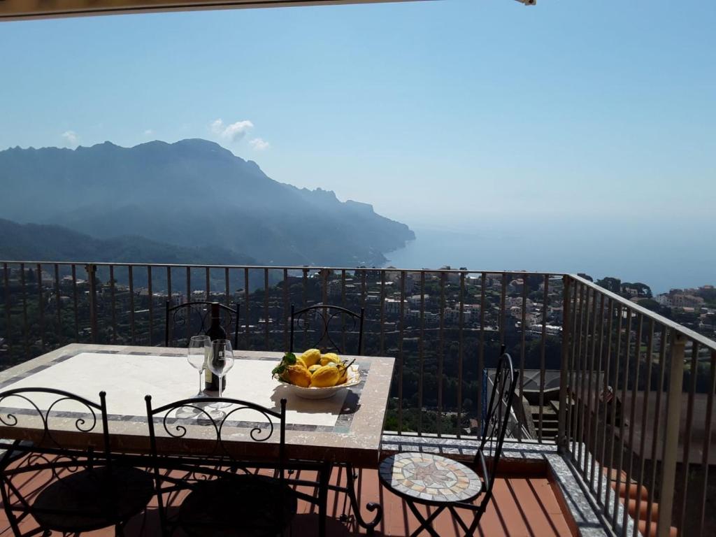 a table with a bowl of fruit on top of a balcony at Appartamento Elisa in Villa Laura in Scala
