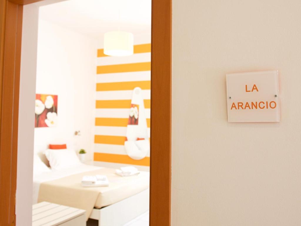 a bathroom with a yellow and white striped wall at La Casa di Rinaldo B&B in Scerne