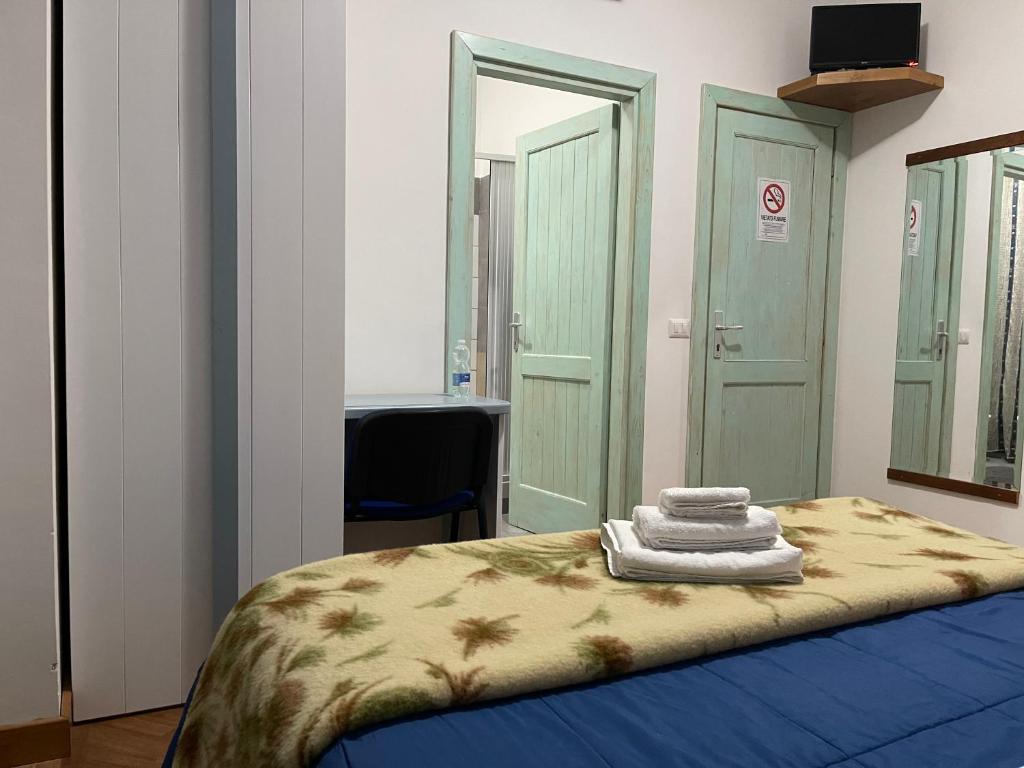 A bed or beds in a room at Affittacamere Le Ginestre