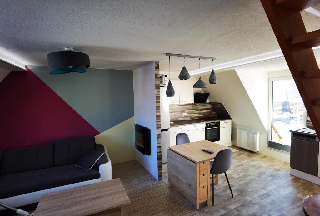 a living room with a couch and a table at Gemütliche Dachwohnung mit kleiner oder großer Dachterrasse nebeneinander in Wolmirstedt