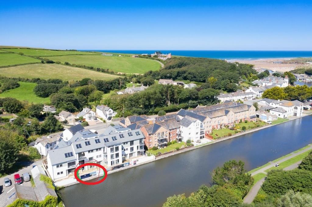 an aerial view of a house with a sign in the water at Canalside Bude in Bude