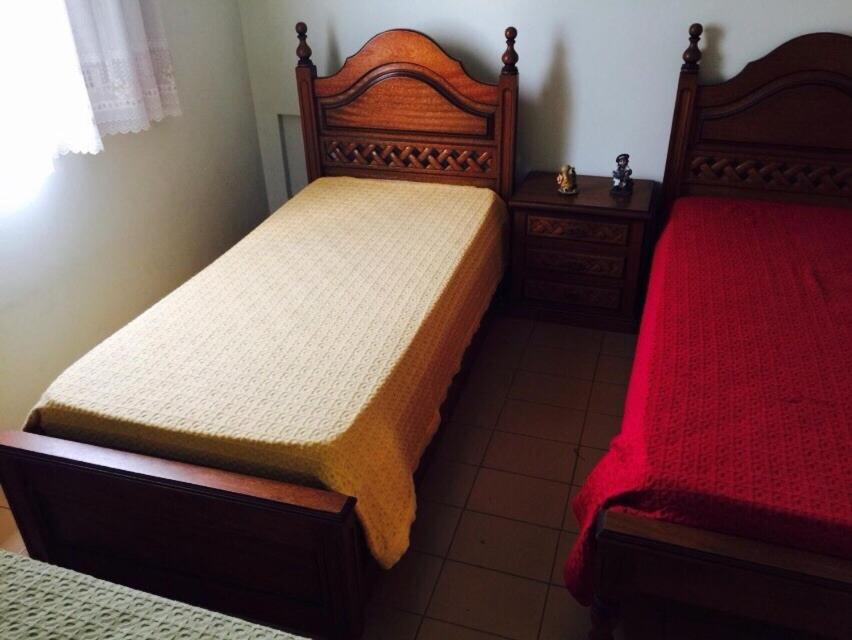 a bedroom with two beds and two night stands at Enseada à 450m da praia in Guarujá