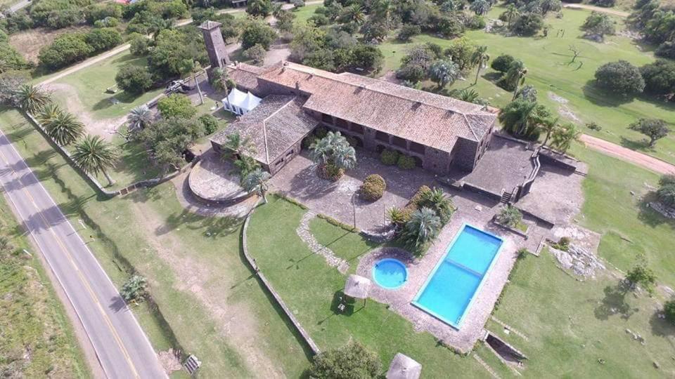 an aerial view of a house with a swimming pool at Hosteria Fortin de San Miguel in Chuy