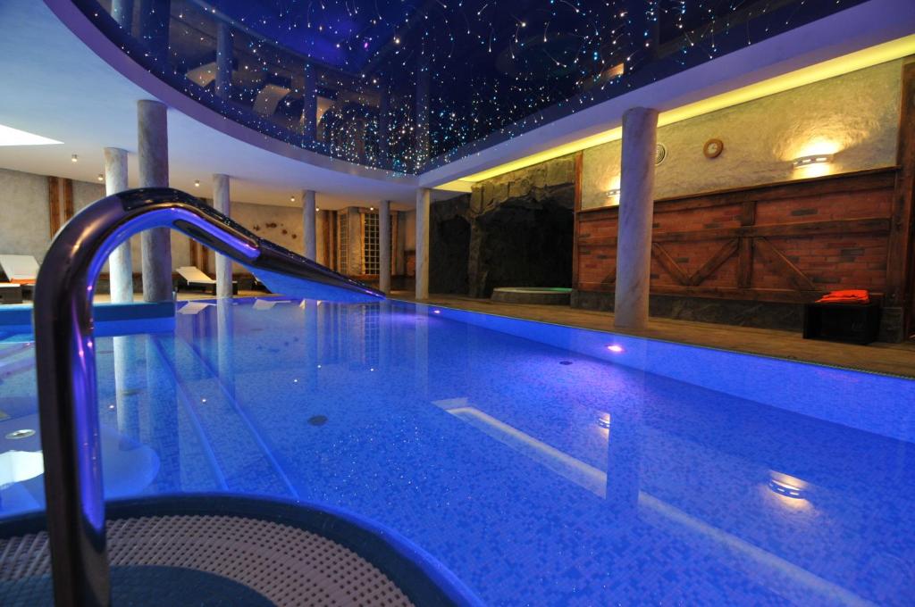 a swimming pool with a water slide in a house at Hotel Kryształ Conference & Spa in Szklarska Poręba