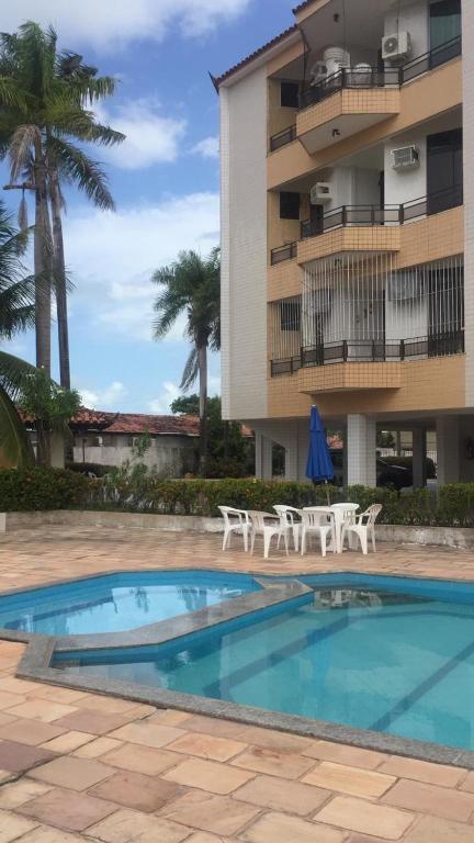 a swimming pool in front of a apartment building at Apto Salinas in Salinópolis