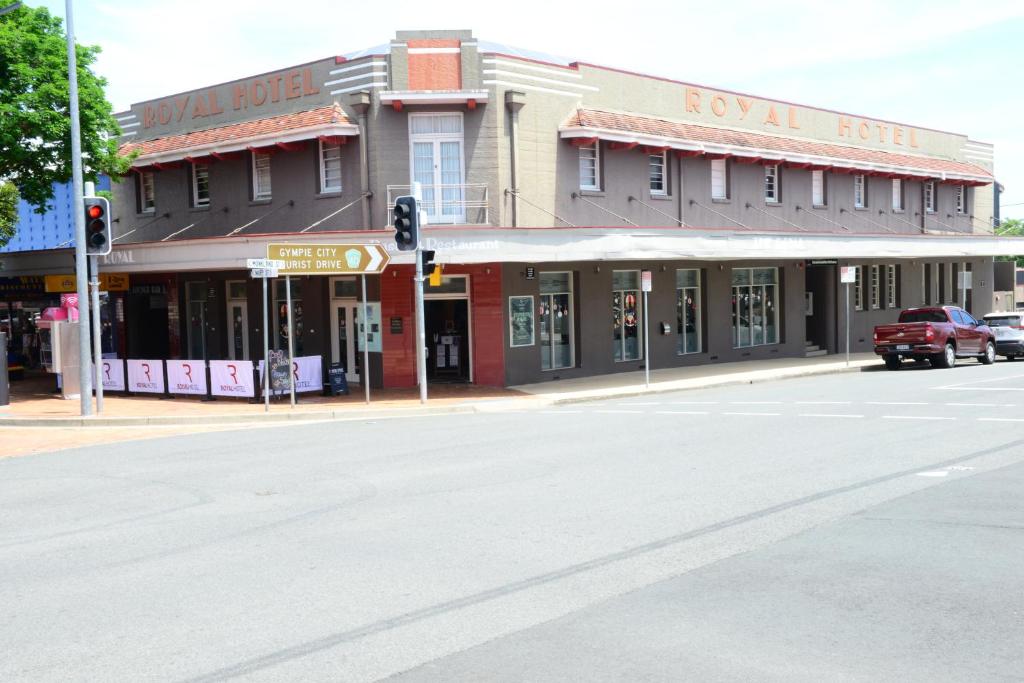 a street scene with cars parked on the side of the street at Royal Hotel Gympie in Gympie