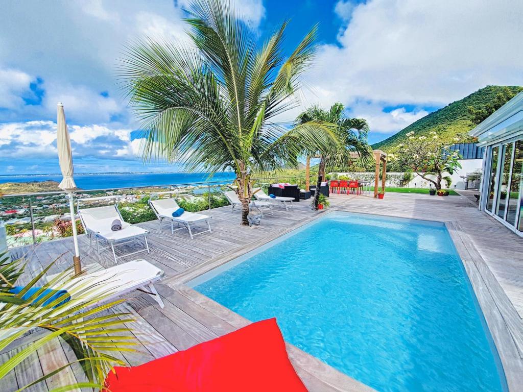 a swimming pool with a view of the ocean at Villa SEA VIEW, 5 min from the beach, overlooking the caribbean sea, private pool in Friar's Bay