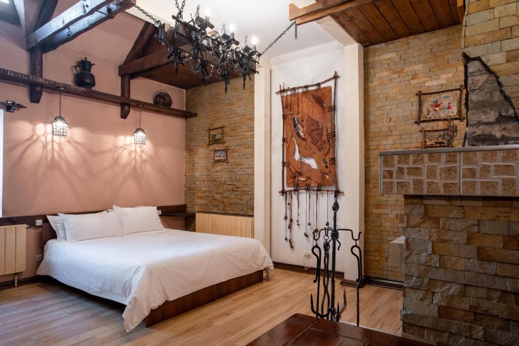 a bedroom with a bed and a brick wall at Asian Mountains in Bishkek