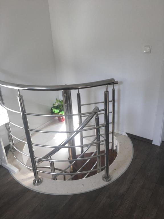 a round table with a glass top on a wooden floor at Apartments Lumbarda in Lumbarda