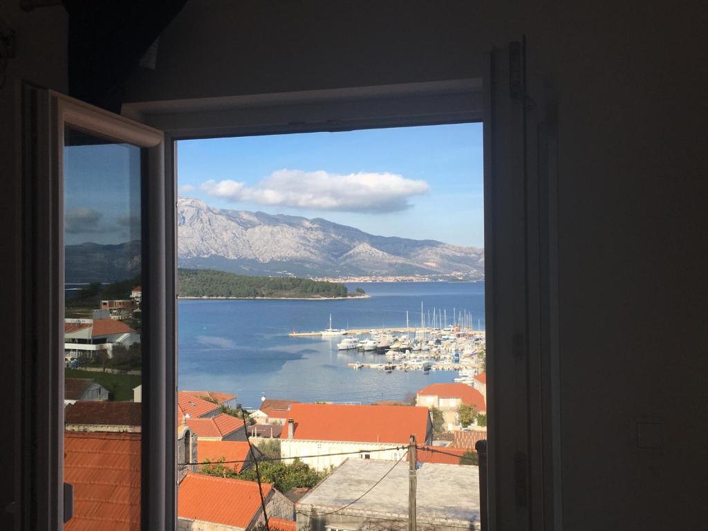 a view of a harbor from a window at Apartments Lumbarda in Lumbarda