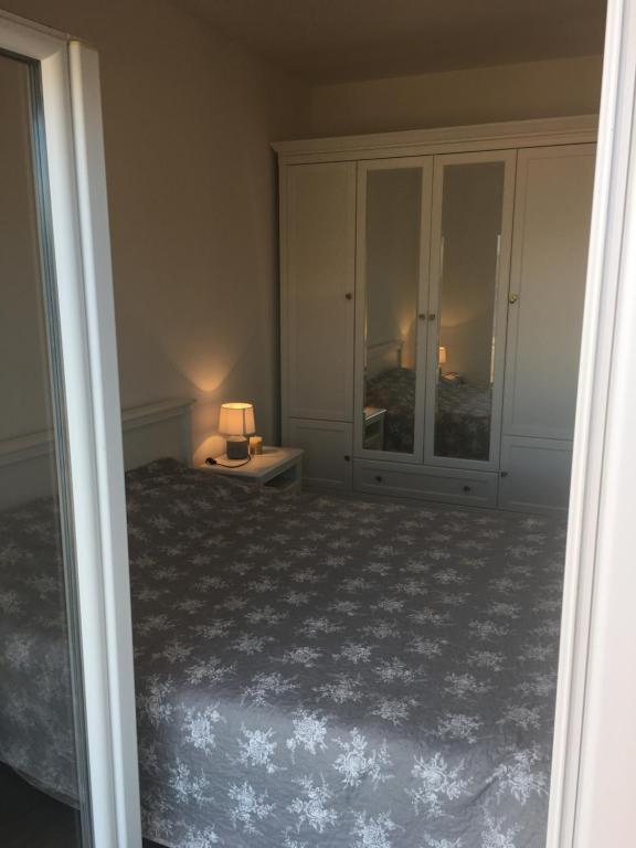 a bedroom with a bed and a lamp on a table at Apartments Lumbarda in Lumbarda