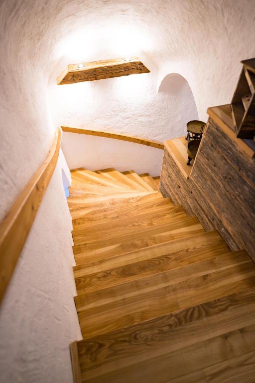 a staircase in a house with wooden floors at Tourist Farm Šenkova Domačija in Zgornje Jezersko