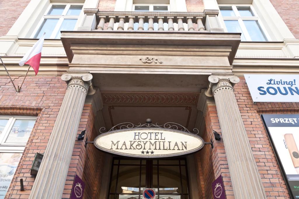 a sign on the front of a building at Hotel Maksymilian in Krakow